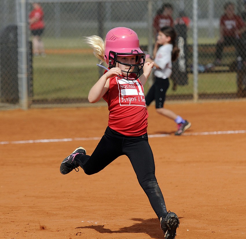 Seven-year-old Erin McIntyre races down to first base.