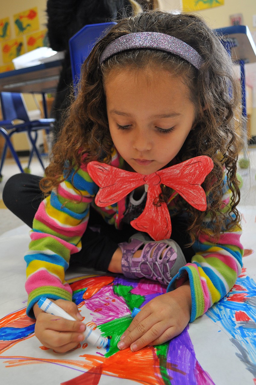 Khendal Clark colors in her Dr. Seuss attire.