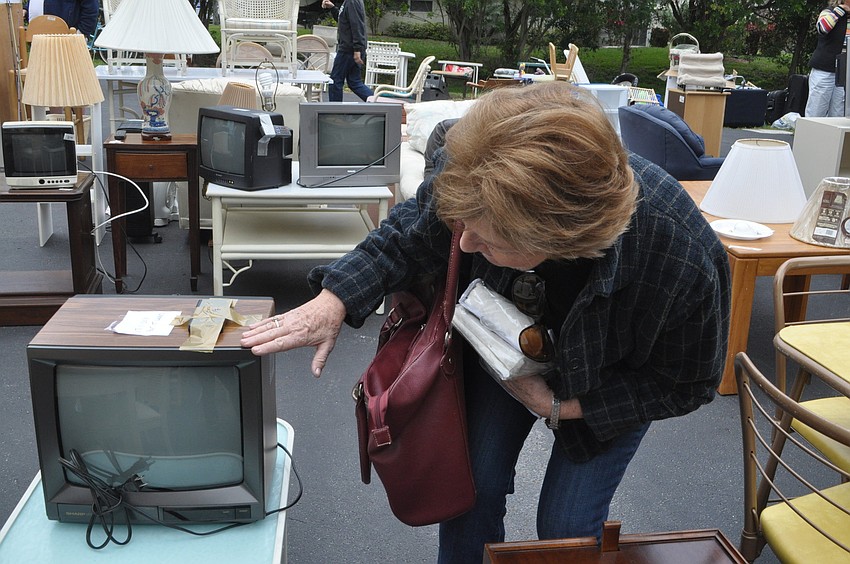 Pat Lotz checks out a television set