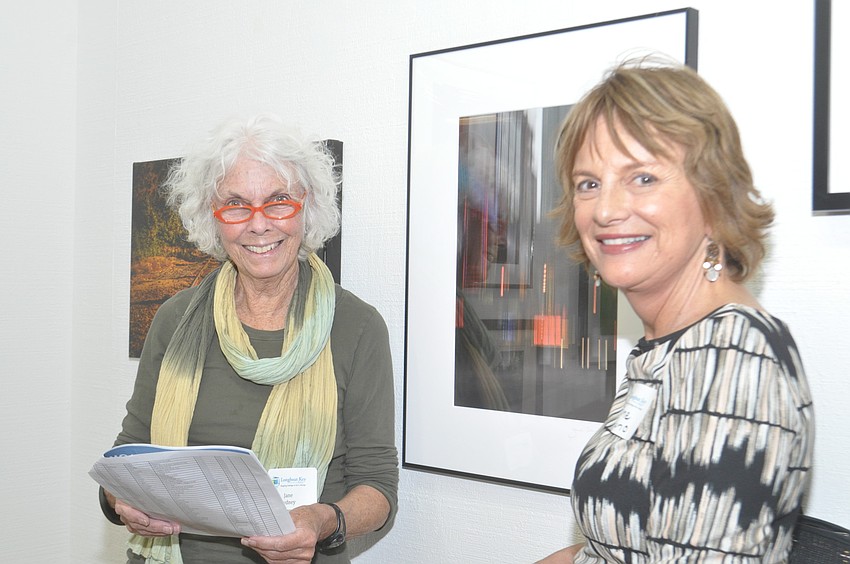 Jane Sydney and Jane Bruno pose with Brunoâ€™s photograph of lights on 42nd Street.