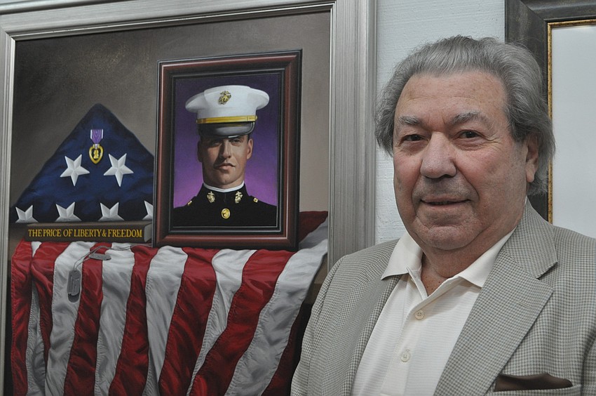 Ralph Garafola with his painting of a fallen marine.