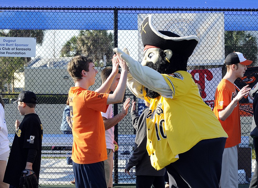 The Bradenton Marauders mascot congratulates 12-year-old Ryan Swain on a well-played game.