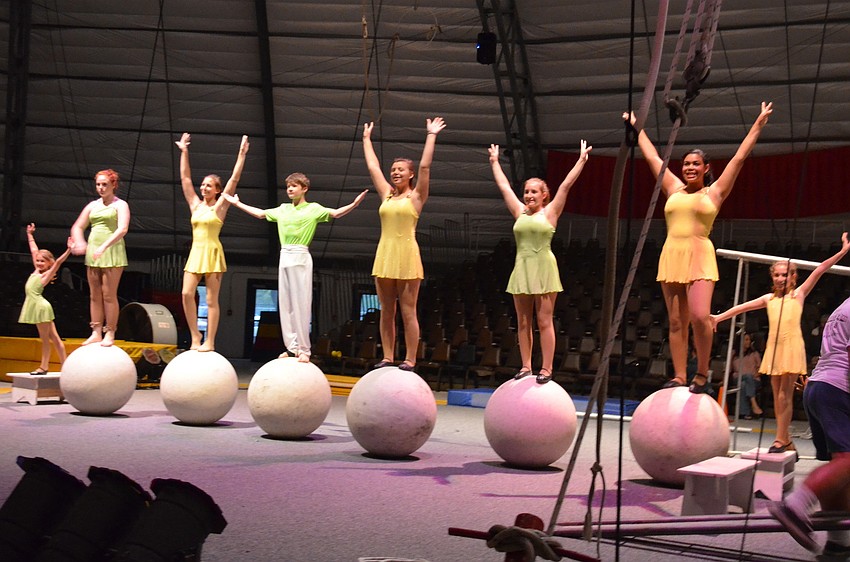 Sailor Circus performers balance on globes