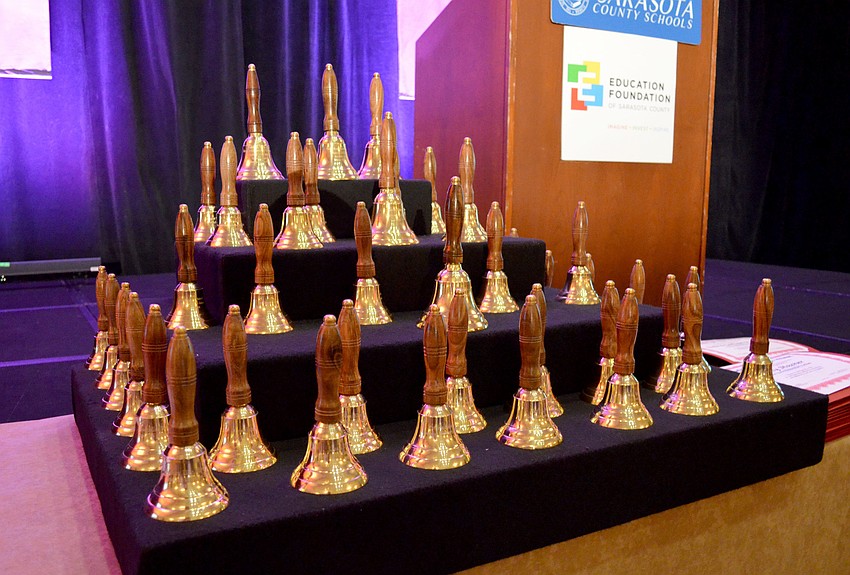 School board members award teachers of the year with school bells each year.