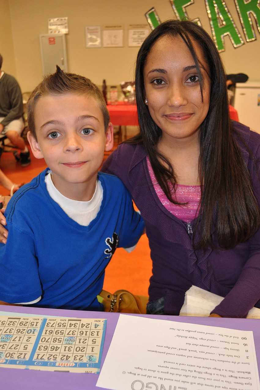 Fourth-grader Kyle Smith and his mother, Carmen, munched on popcorn as they played.