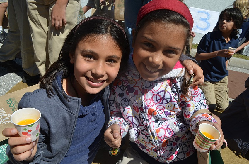 Fourth graders in Mr. Robert Scuteriâ€™s class Kaylee Yunis and Lauren Kazzab sample fresh squeezed orange juice the Browns Grove zone.