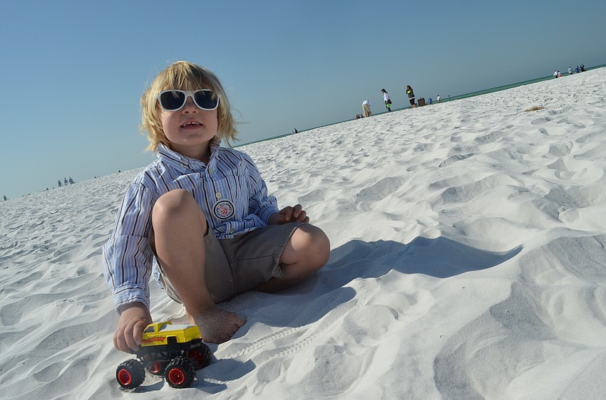 Charlie Frohlich plays in the sand.