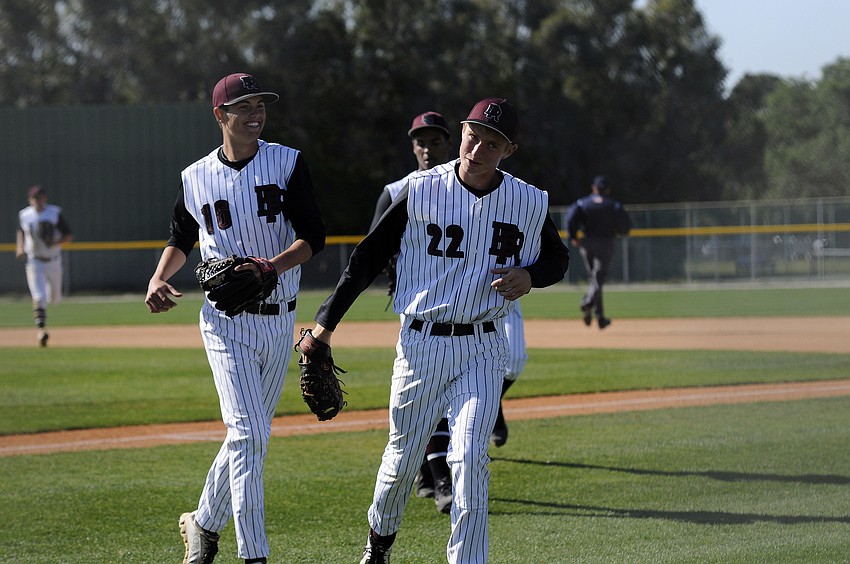 Braden Riverâ€™s Derrick Cozzette and Cole Pencosky celebrate after closing out a scoreless inning.