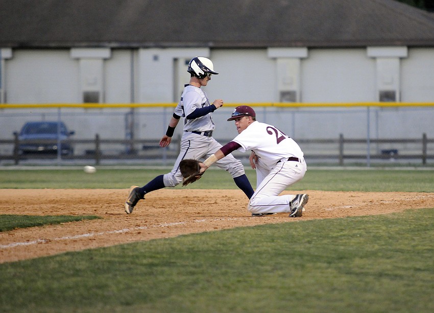 Riverview first baseman Alex Detweiler attempts to catch a Gulliver Prep base runner off of the bag.