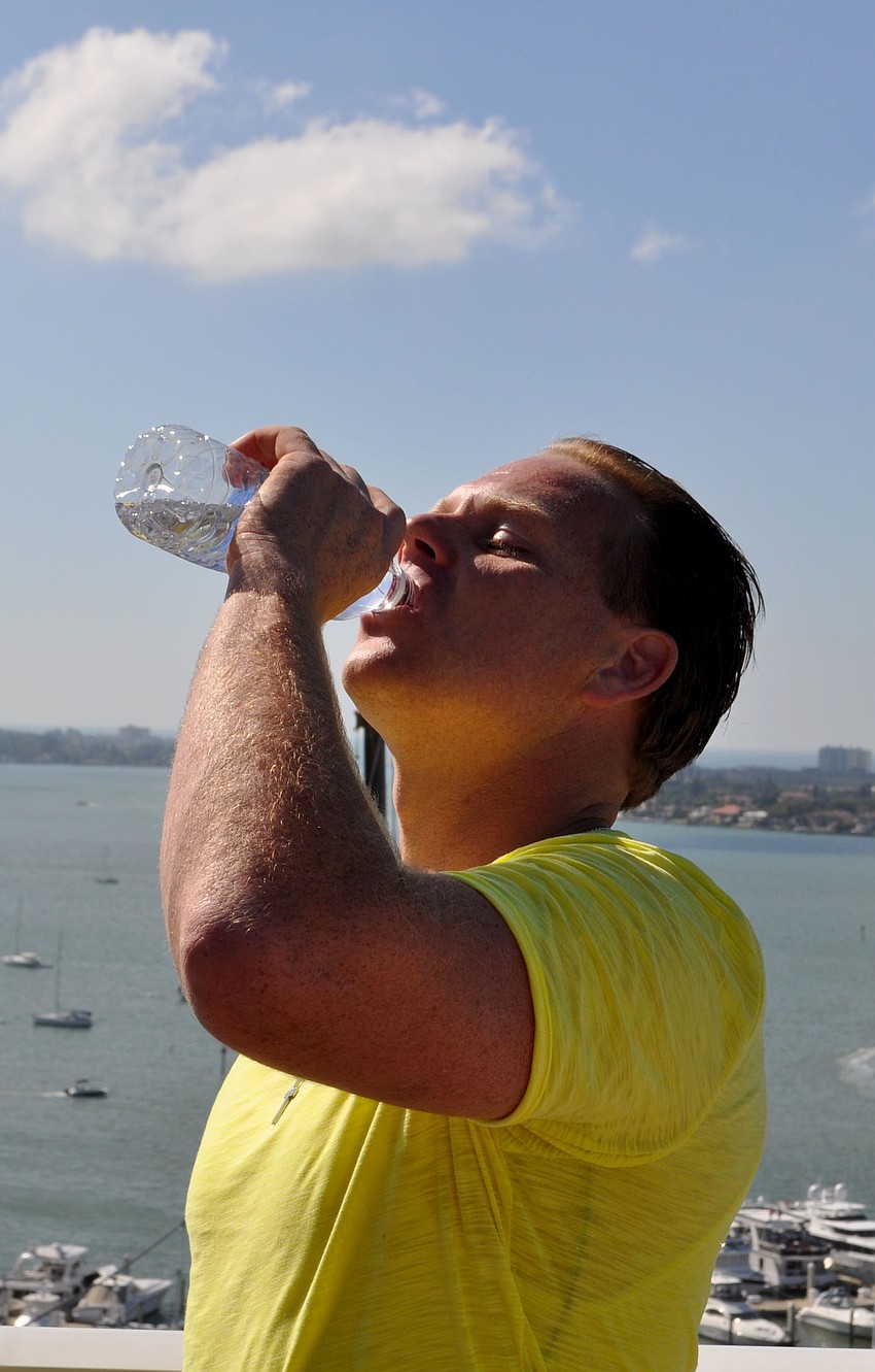 Wallenda drinks a bottle of water after his walk.