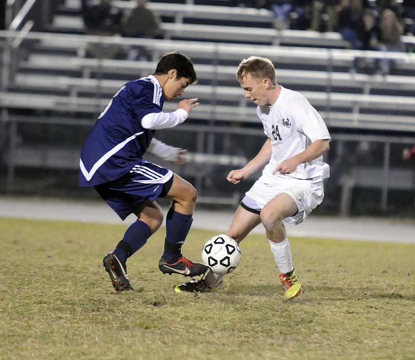 Lakewood Ranch forward Ryan Sollazzo battles a Manatee High defender for possession in the second half. Sollazzo scored both goals for the Mustangs.