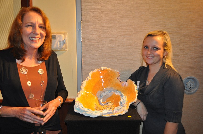 Sydney Collier, a Bayshore High School junior, displayed her piece, titled â€œEb and Flowâ€ to Diane Rosenbarger.