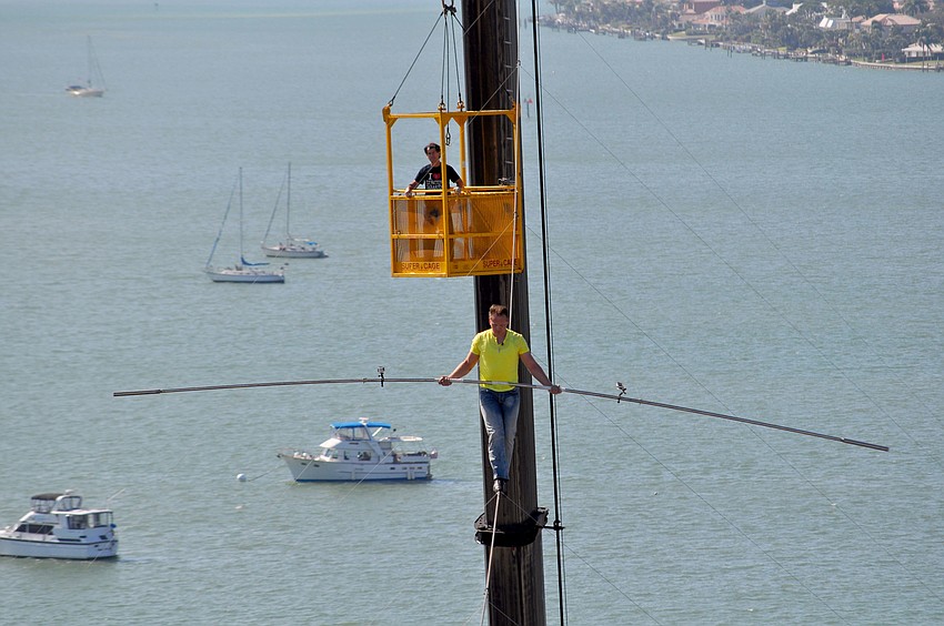 Wallenda begins his walk, while Pedro Reis looks on.
