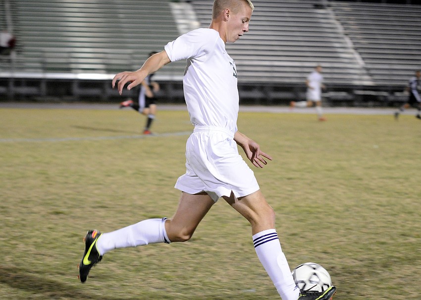 Defender Reese Riggins pushes the ball up the field for the Mustangs in the second half.