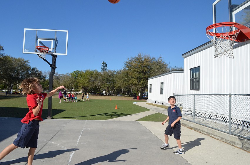 Fourth graders Kane Coose and Domenic Maglio shoot hoops.