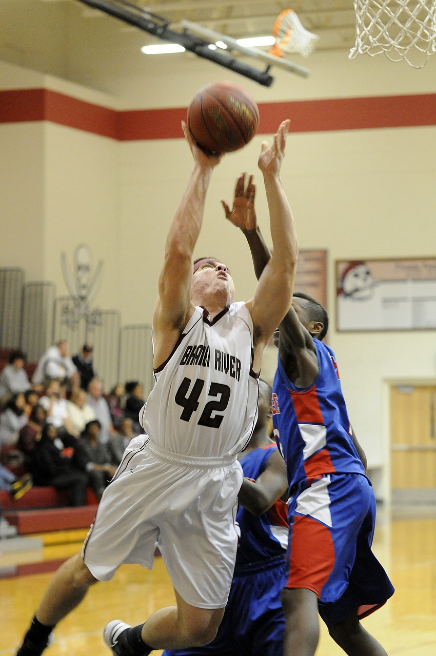 Braden River senior forward Patrick Tart is fouled while going up for a shot.