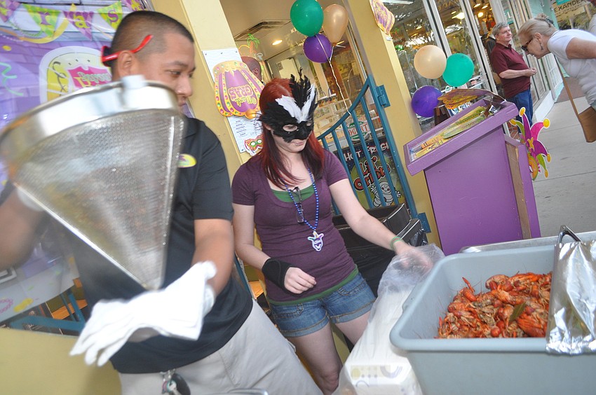 Noe Carmona and Ashleigh Lee serve complimentary crawfish outside Daiquiri Deck