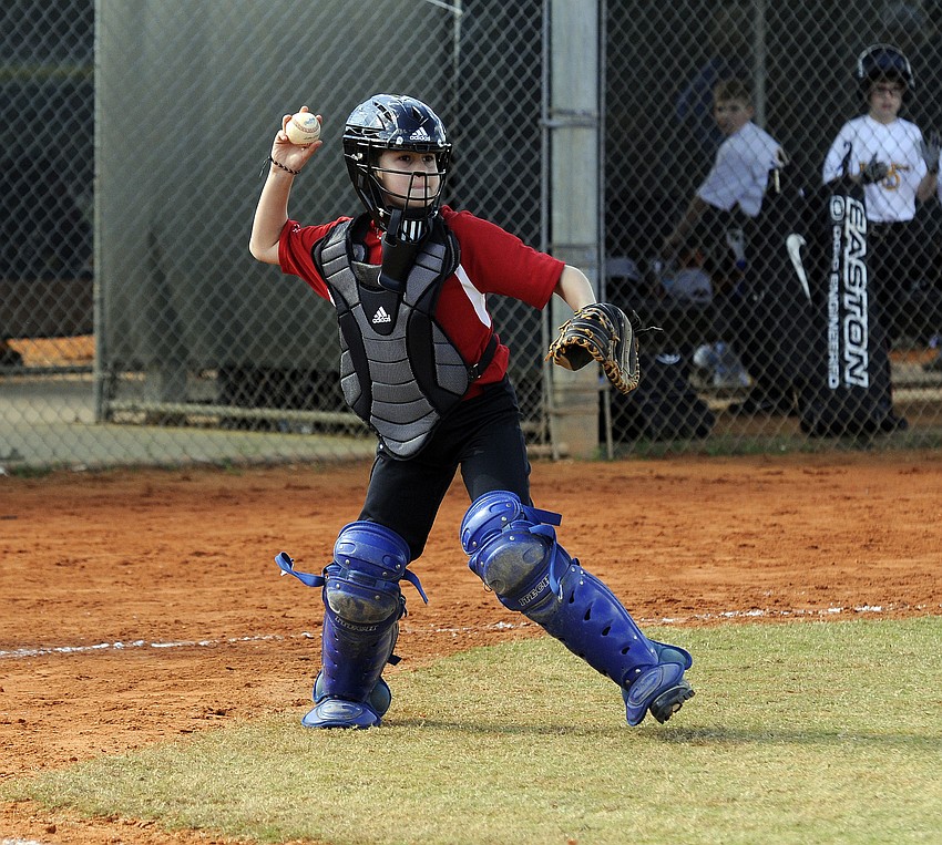 Catcher Logan Walker, 11, throws the ball back down to first base.