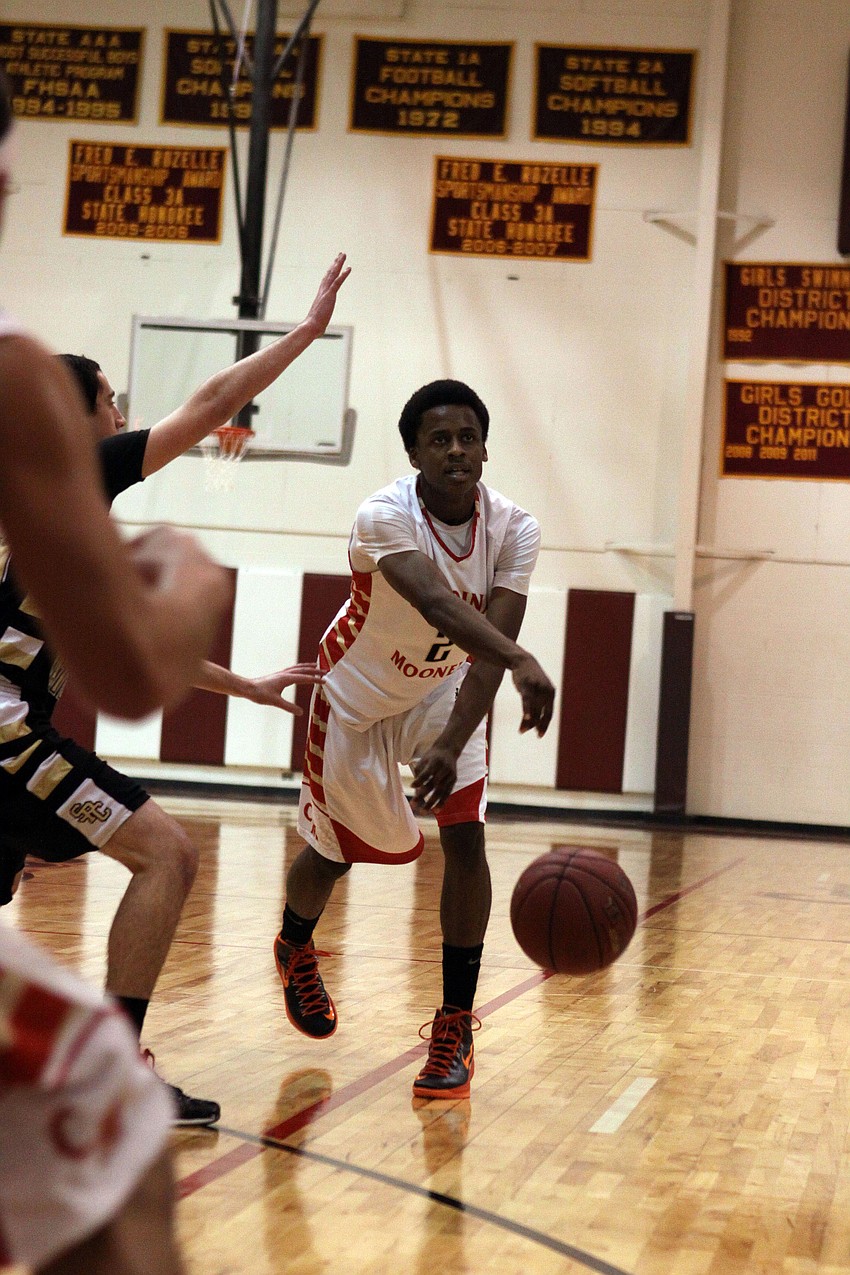 Cardinal Mooneyâ€™s Antonio Blakeley, No. 2, bounce passes the ball.