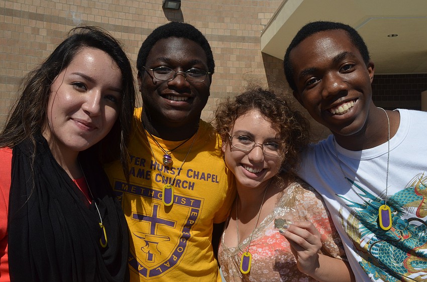 Seniors Amy Galloza, Dylan Rock, Erica Janko, and Treyvon Thomas all wear gold dog tags signifying a 4.0 GPA or higher.