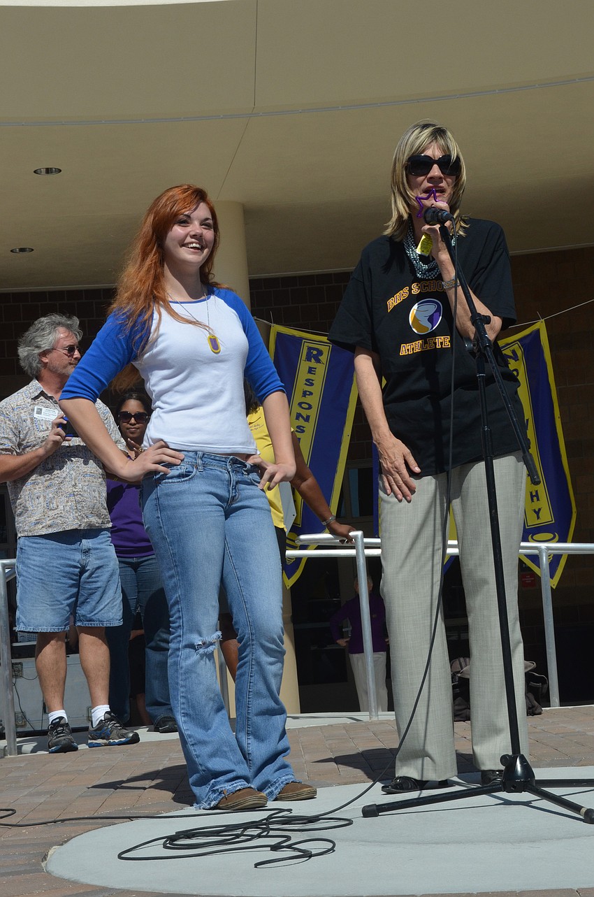 Mayor Susan Atwell congratulates sophomore Megan Adams on winning the 2002 Saturn SL and gets ready to hand her the keys.