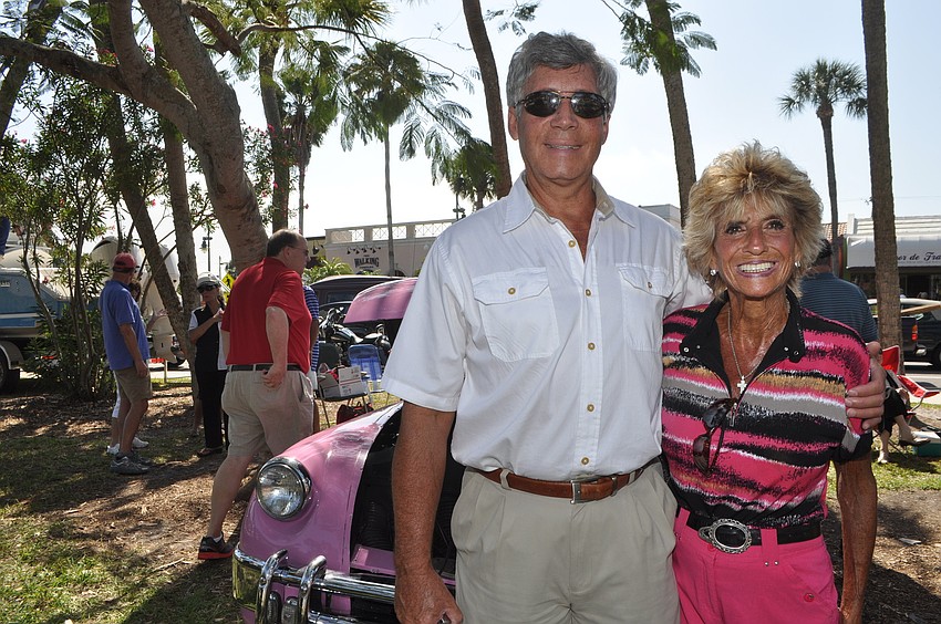 Mike Cole and Carole Covino pose with a pink 1952 Muntz convertible.