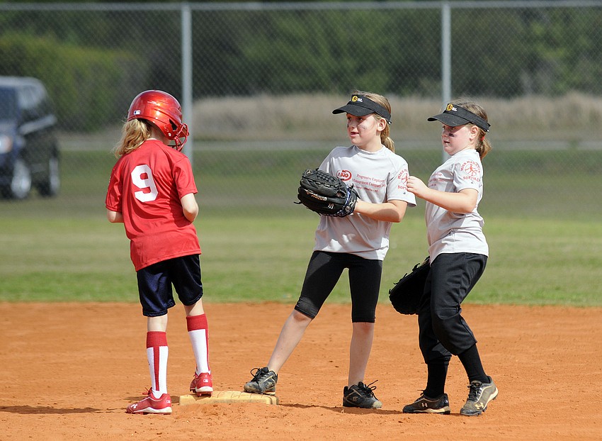 Reagan Wilson, 9, beats the tag from Pemcoâ€™s Kimberly Koelsch, 8, and Mya Blue, 7.