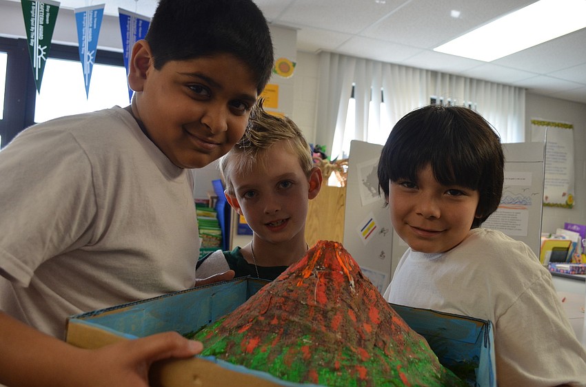 Third graders Neel Patel and Jordan Calvillo made a volcano for their project and second grader Liam Holzler (middle) came to check it out.