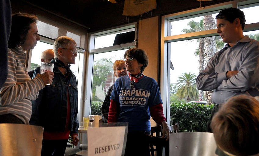 Susan Chapman talks to supporters at her watch party.