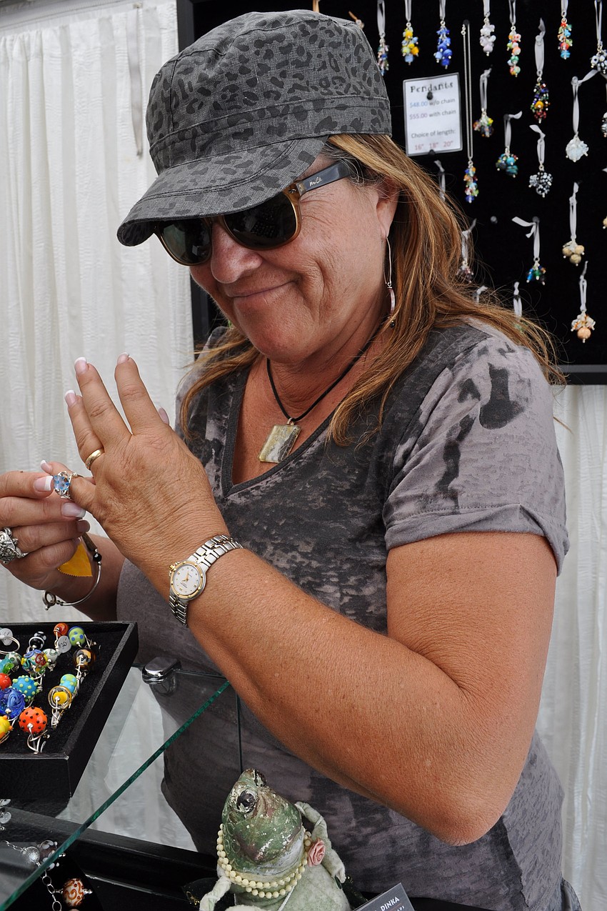 Ann Segal admired glass bead rings created by artist Dianna Dinka.