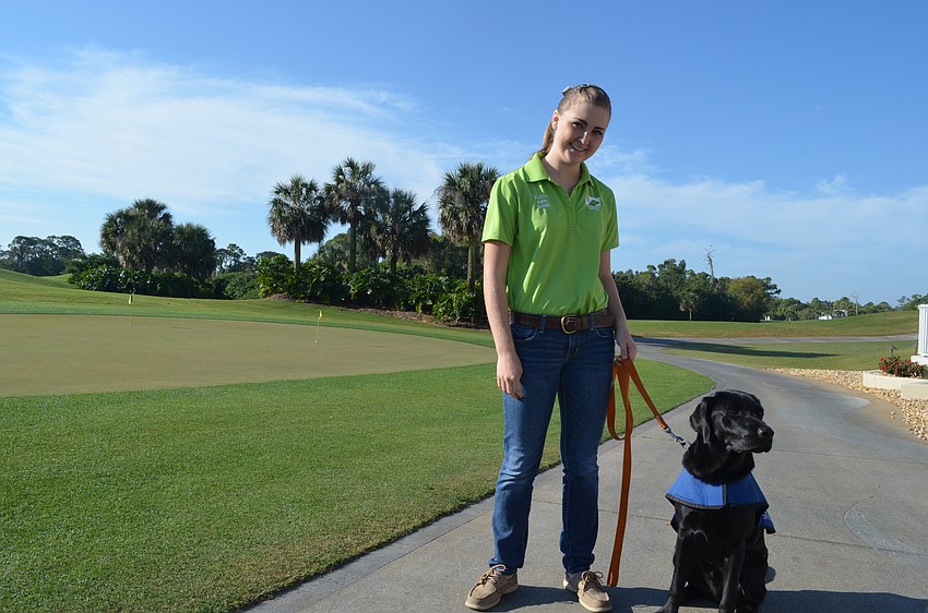 Puppy raiser Katie Redmann stands with Stoney. Stoney turned 1-year-old Saturday, March 16, and was named after the Stoneybrook neighborhood for their generosity through the years.