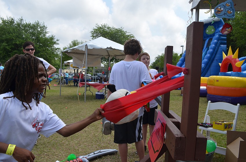 Josiah Booker plays an Angry Birds carnival game.
