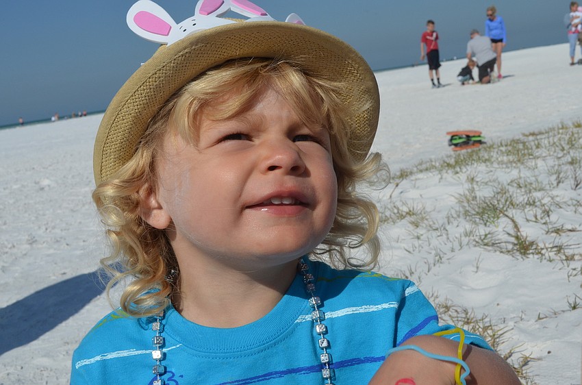 Elliot Steinfels plays in the sand after finding five of his Easter eggs.