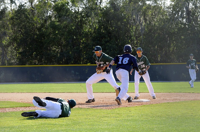 Lakewood Ranch first baseman Brad Zunica catches a flip from pitcher Colton Chupp for an out.