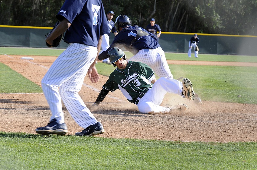 Lakewood Ranch junior Justin Greenaway slides across home plate to give the Mustangs a 2-0 lead.