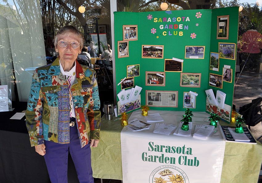 Catherine LaBrie stands in front of the Sarasota Garden Club membership board.