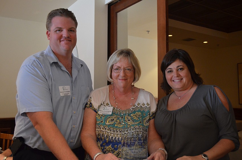 Richard Cunningham, him mother Sharon and Alana Tomasso accept the Large Business of the Year Award. Cunningham Property Management has 47 employees and has been operating since 1985.