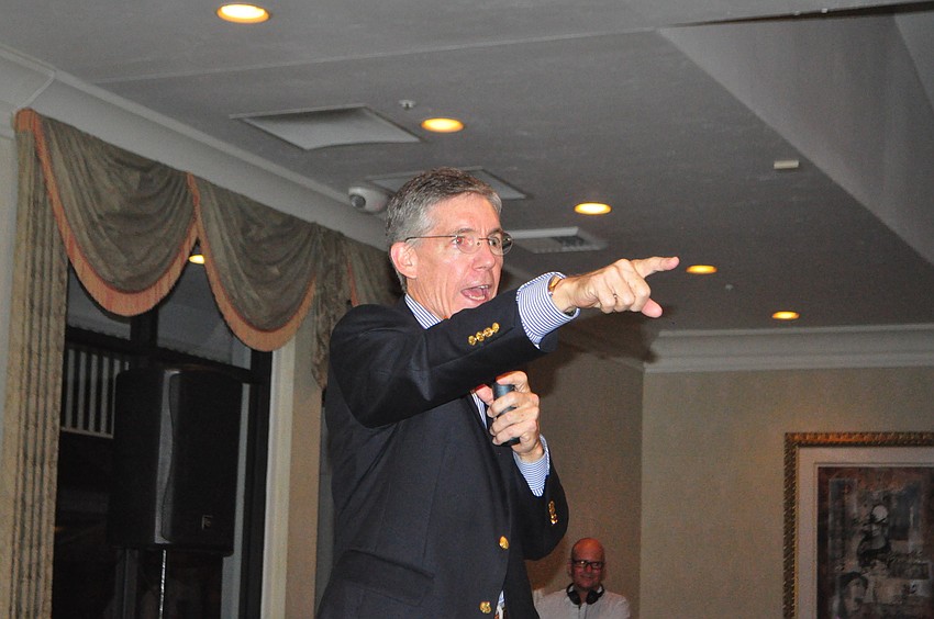 Emcee Matt Walsh auctions off an 