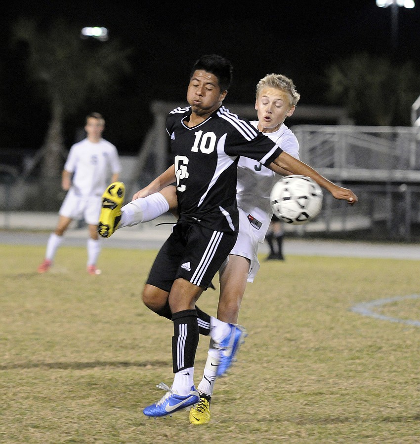 Lakewood Ranch midfielder Jake Dube, back, battles Naples Gulf Coast midfielder Erick Santiago for possession during the Class 4A-Region 3 quarterfinals Jan. 30.