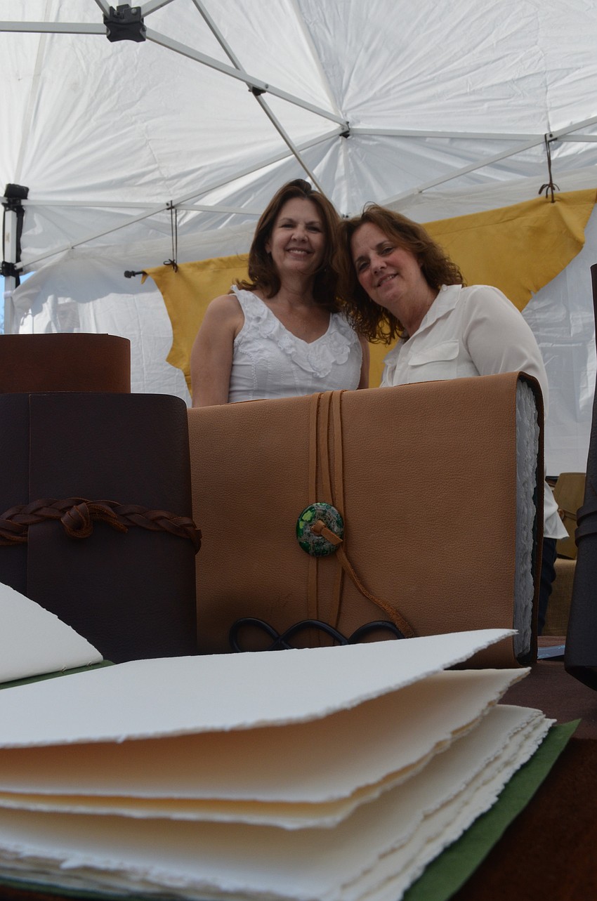 Pam McRee and Priscilla Elfrink make leather bound journals and books. They tear the paper by hand and sew the journals