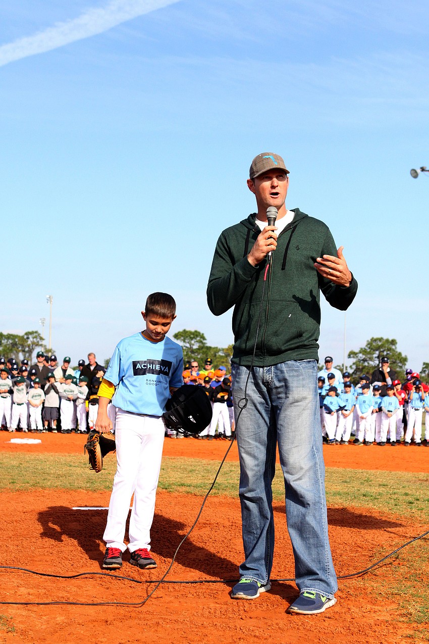Matt Drews, former Sarasota Little League player, MLB player and now coach for Sarasota Little League, talks to the crowd during opening day.
