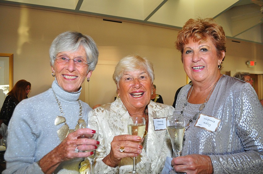 Sue Kemper, Nancy Chanos and Virginia Kelly shine in metallic outfits.