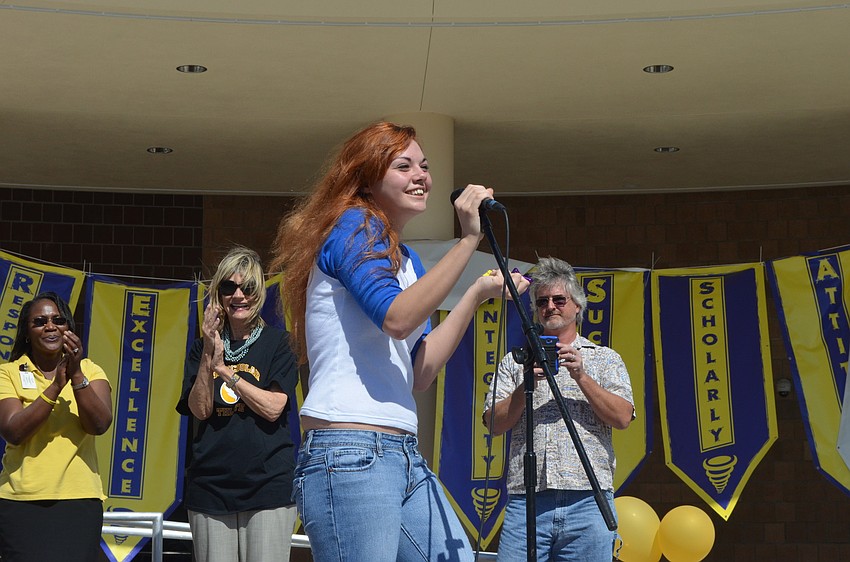 Megan Adams thanks staff after winning the 2002 Saturn SL.