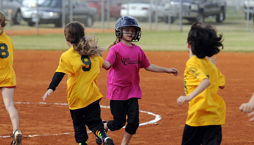 Vogel Constructionâ€™s Kelsey Vogel, 8, congratulates Gator Air players on a good game.