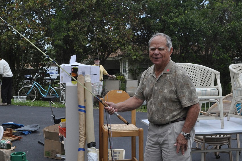John Pappas tries out a fishing rod.