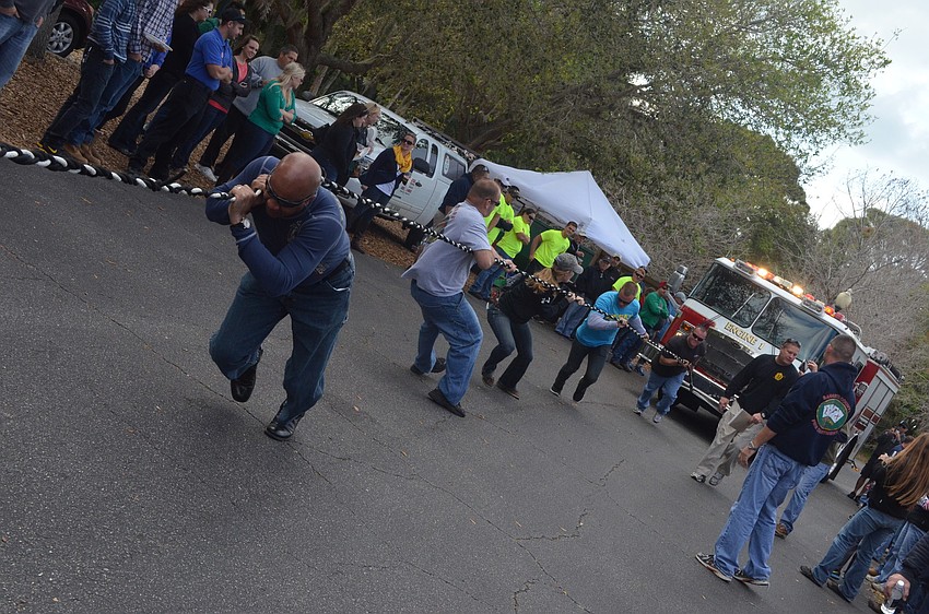 Mike Vance and Station 1 firefighters pull the 40,000-pound fire truck in the Pumper Pull Challenge.