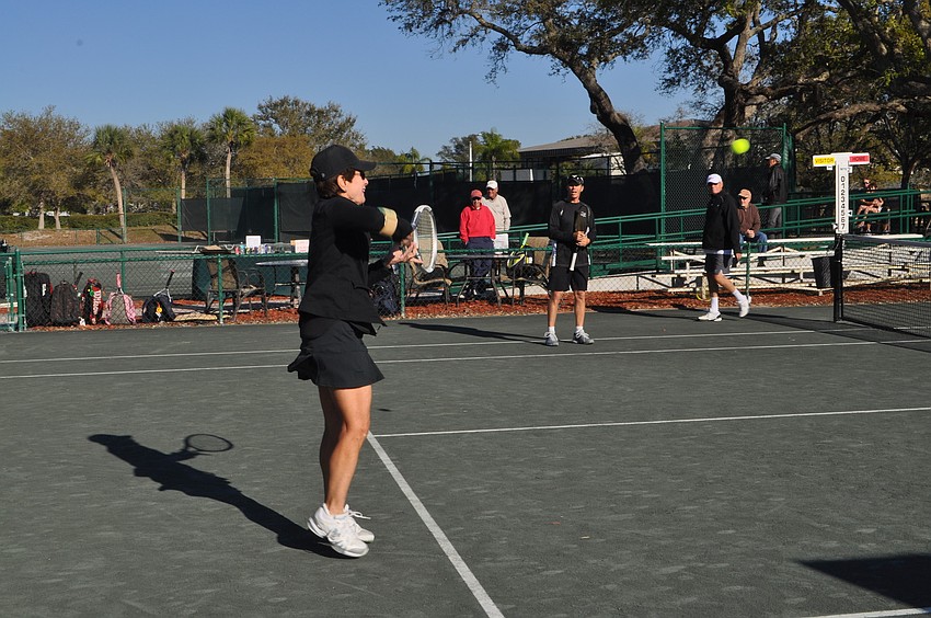 Andy Moses watches her backhand return.