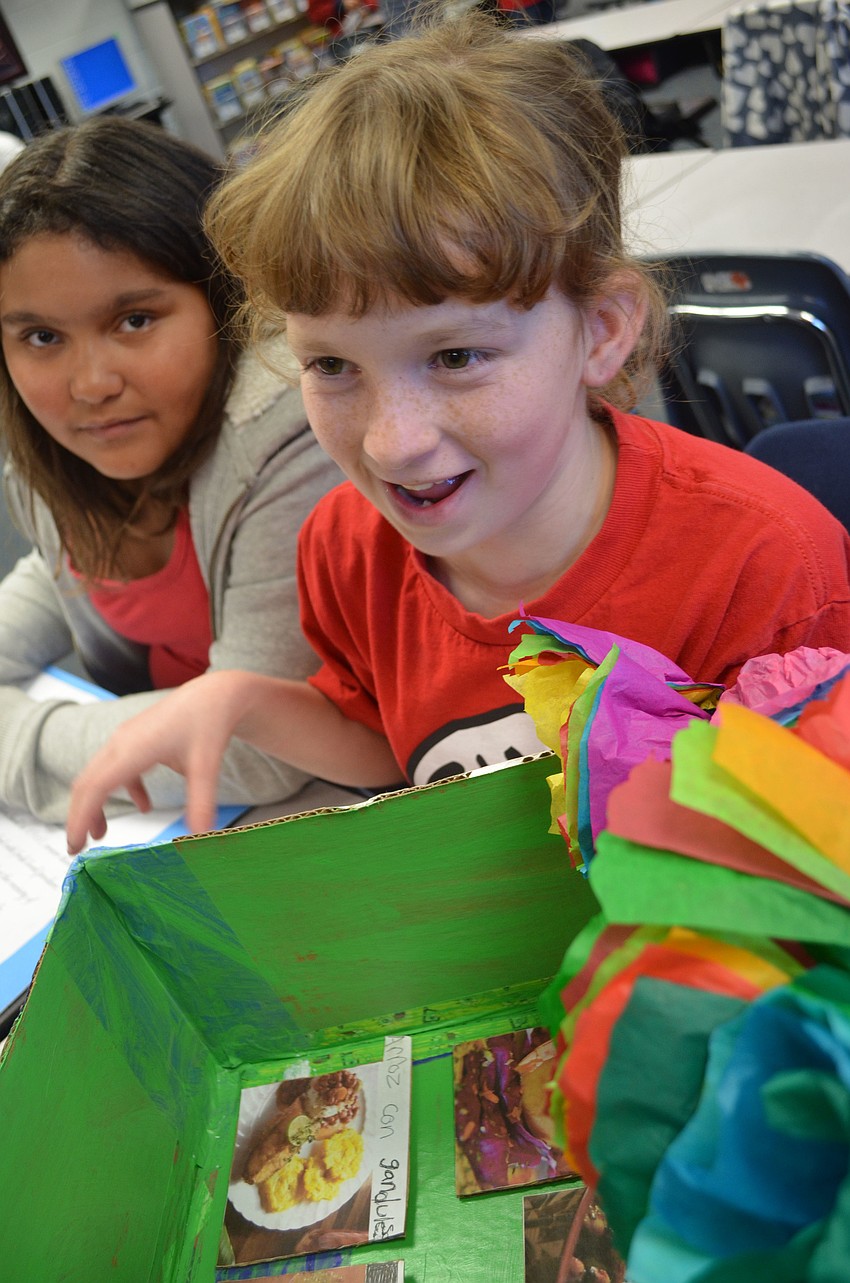 Jessica Richtmyer and Destiny Barnes explain their project to visiting classrooms.