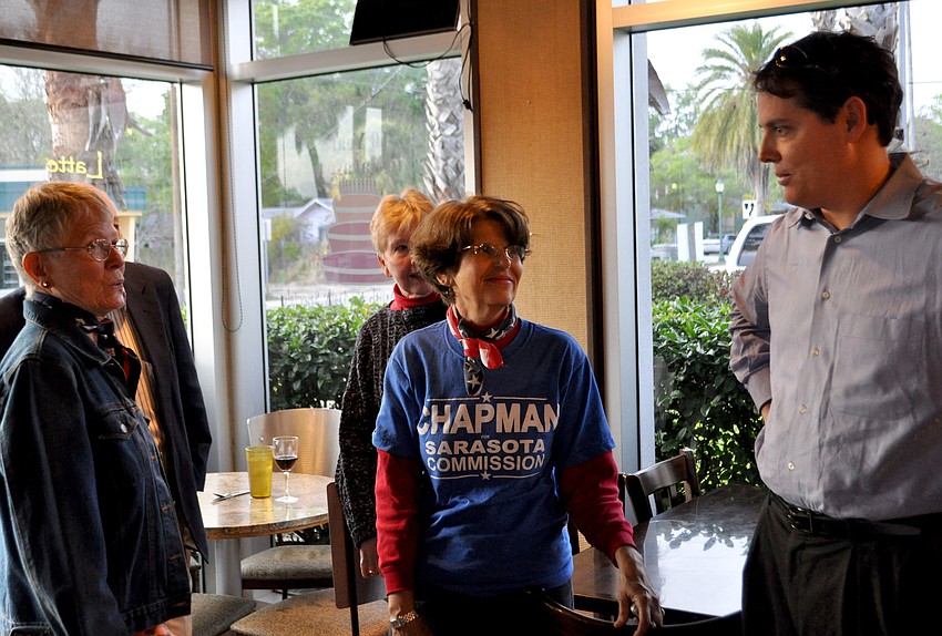 Susan Chapman talks to supporters at her watch party.