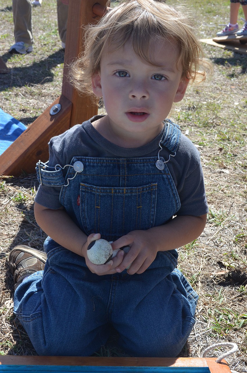 Fisher Kai Bradford, 2, plays a fishing game in Pinocchioâ€™s Land.